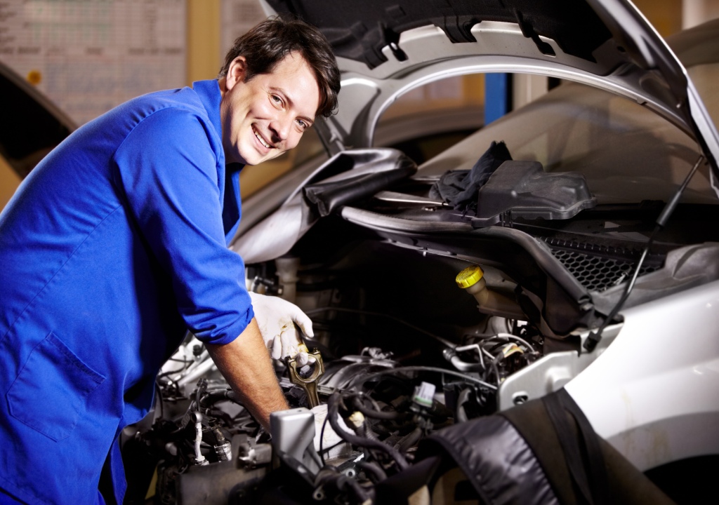 Mechanic working at a vehicle engine bay